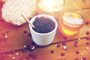 Image showing close up of coffee scrub in cup and honey on wood