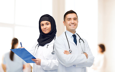 Image showing happy doctors with clipboard and stethoscopes