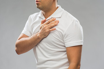 Image showing close up of man with heart ache or chest pain