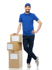 Image showing happy delivery man with parcel boxes