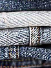 Image showing close up of denim clothes or jeans pile