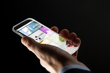 Image showing close up of hand with apps on smartphone