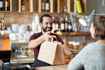 Image showing man or waiter serving customer at coffee shop