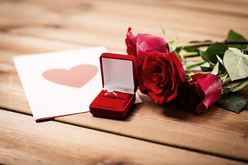 Image showing close up of diamond ring, roses and greeting card