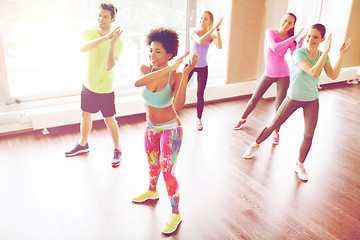 Image showing group of smiling people dancing in gym or studio