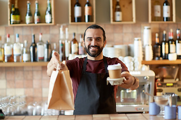 Image showing man or waiter with coffee and paper bag at bar