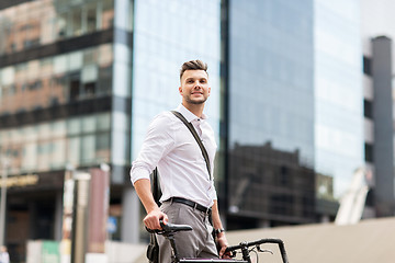 Image showing young man with bicycle on city street