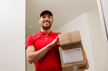 Image showing delivery man with parcel boxes at customer door