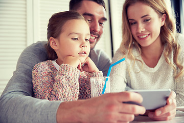 Image showing happy family with smartphone at restaurant