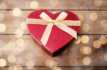 Image showing close up of heart shaped gift box on wood