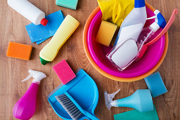 Image showing basin with cleaning stuff on wooden floor