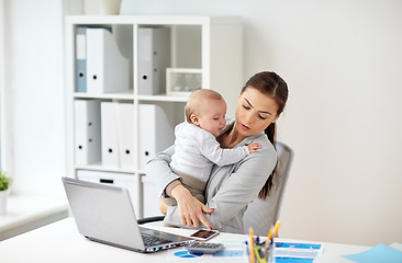 Image showing businesswoman with baby and smartphone at office