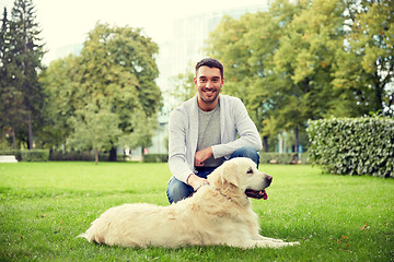 Image showing happy man with labrador dog walking in city