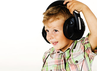 Image showing young pretty little cute boy kid wondering, posing emotional face isolated on white background, gesture happy smiling close up, wearing headphones, lifestyle people concept