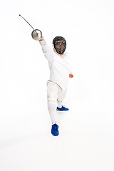 Image showing Man wearing fencing suit practicing with sword against gray