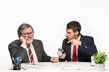 Image showing The two colleagues working together at office on white background.