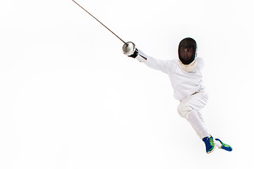 Image showing Man wearing fencing suit practicing with sword against gray