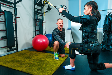 Image showing The female athlete doing they exercise in a ems fitness studio