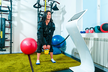 Image showing The female athlete doing they exercise in a ems fitness studio