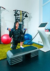 Image showing The female athlete doing they exercise in a ems fitness studio