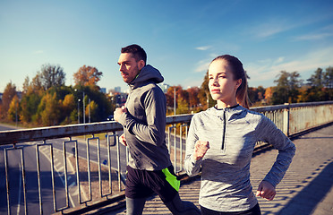 Image showing happy couple running outdoors