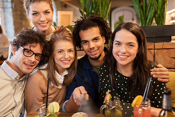 Image showing friends taking selfie by smartphone at bar or cafe