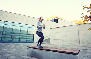 Image showing woman exercising on bench outdoors
