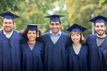 Image showing happy students or bachelors in mortar boards