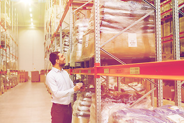 Image showing businessman with clipboard at warehouse