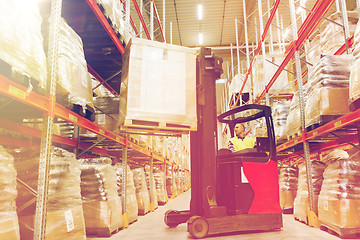 Image showing man on forklift loading cargo at warehouse