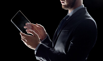 Image showing close up of businessman with transparent tablet pc