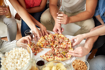 Image showing close up of people taking pizza slices at home