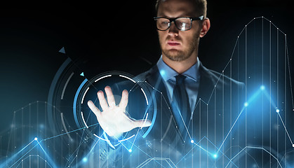 Image showing businessman touching virtual charts projection