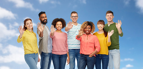 Image showing international group of happy people waving hand