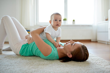 Image showing happy mother playing with baby at home