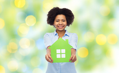 Image showing happy african american woman with green house icon