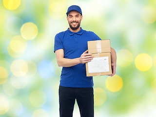 Image showing happy delivery man with parcel boxes