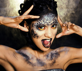 Image showing fashion portrait of pretty young woman with creative make up like a snake, halloween
