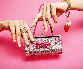 Image showing little girl stuff for princess, woman hands holding small cute handbag with jewelry and manicure, luxury lifestyle concept