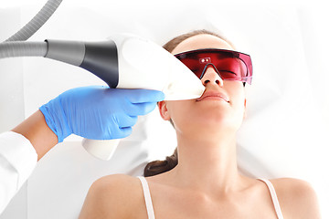 Image showing Cosmetic clinic, a woman during laser hair removal facial