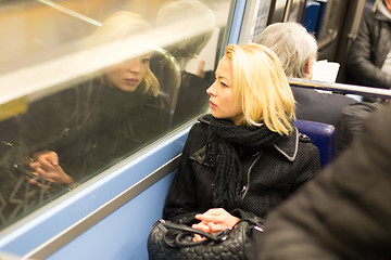 Image showing Woman looking out metro\'s window.