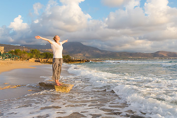 Image showing Free Happy Woman Enjoying Sunset on Sandy Beach