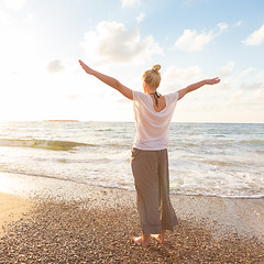 Image showing Free Happy Woman Enjoying Sunset on Sandy Beach