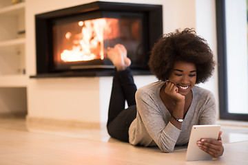 Image showing black women used tablet computer on the floor