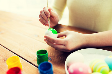 Image showing close up of woman hands coloring easter eggs