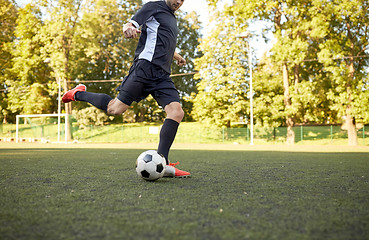 Image showing soccer player playing with ball on football field