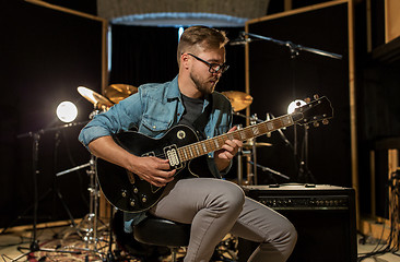 Image showing man playing guitar at studio rehearsal