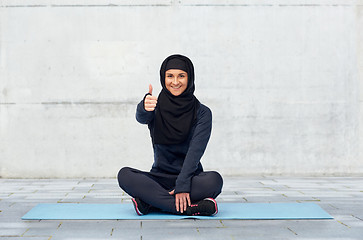 Image showing muslim woman doing sport and showing thumbs up