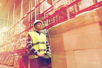 Image showing man on forklift loading cargo at warehouse