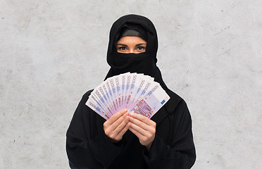 Image showing muslim woman in hijab with money over white